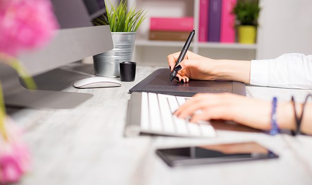 Female working on computer and drawing pad