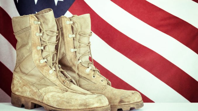 Old combat boots with American flag