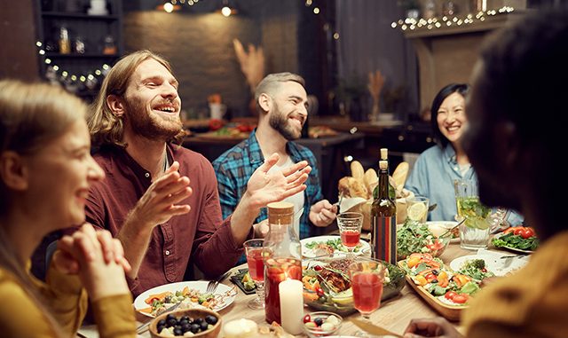 People Laughing at Dinner Table